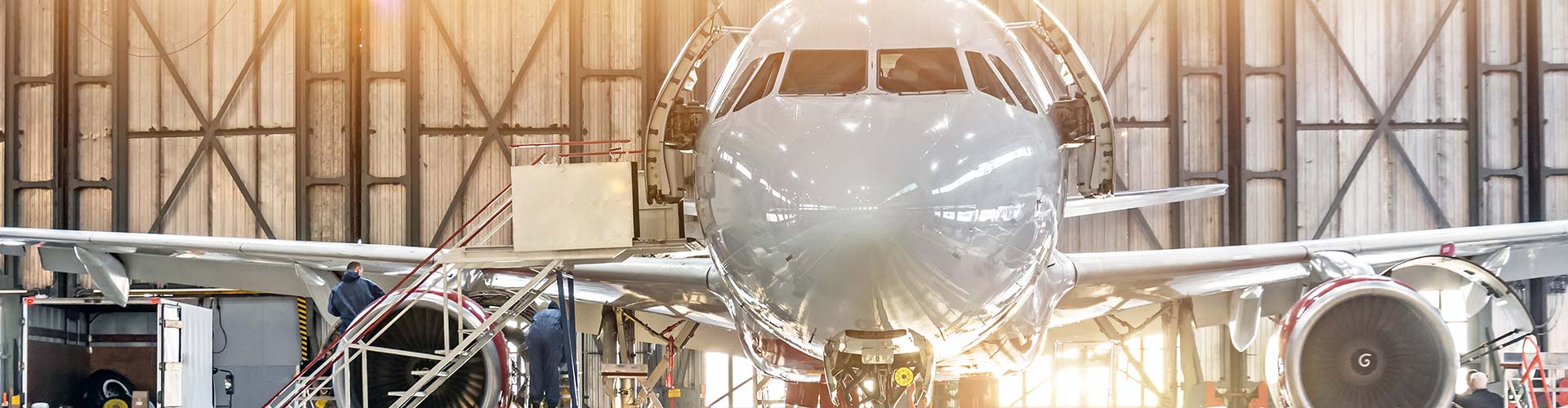 A white aircraft stationed in a hangar for aviation electronics in North Las Vegas